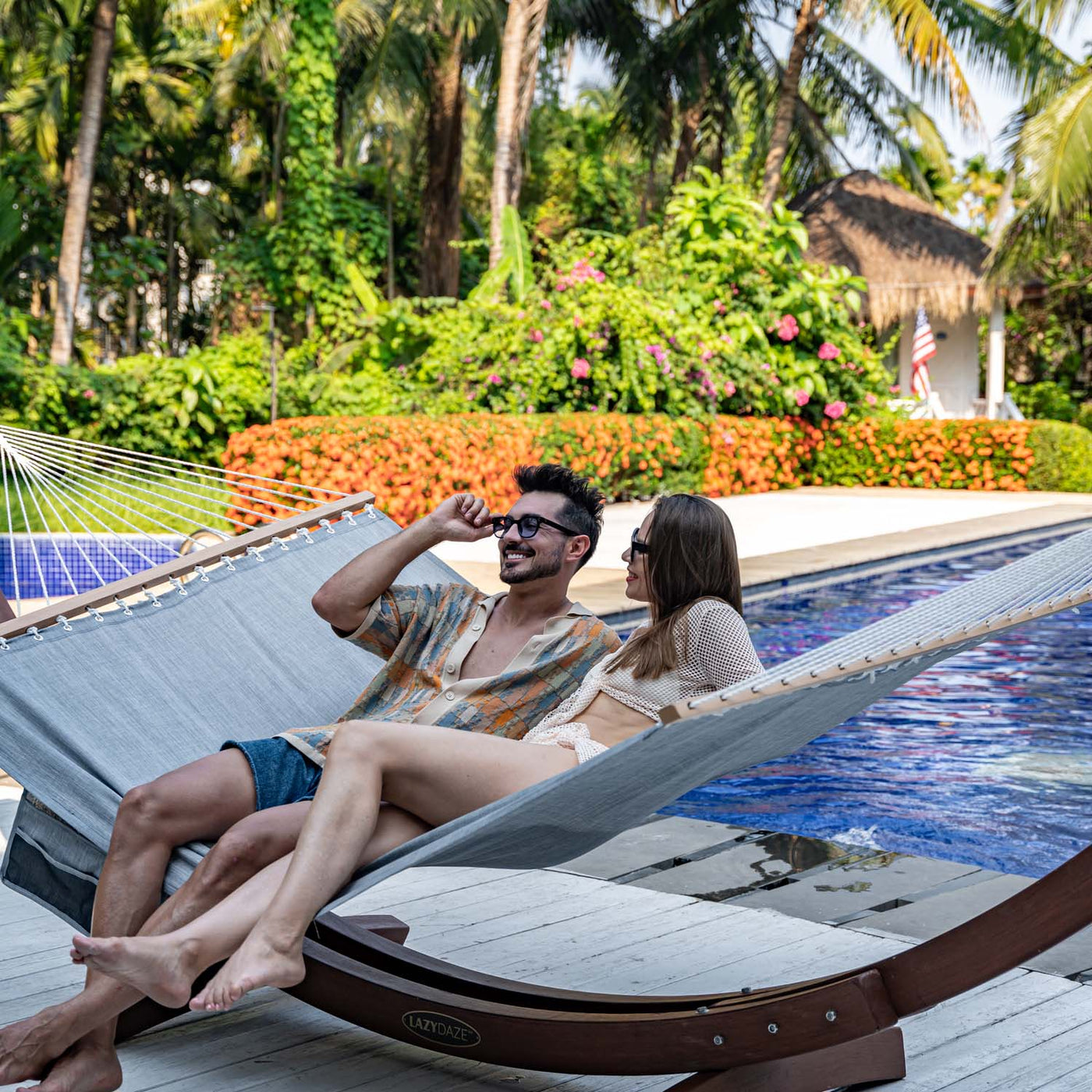 Man and woman relaxing on the Lazy Daze Quick Dry Hammock in Gray in the backyard.#color_gray