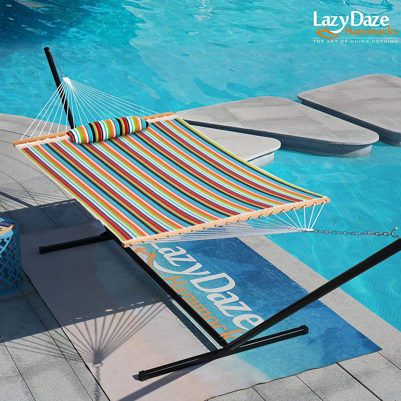 Lazy Daze Sunbrella Double Quilted Hammock in Carousel Confetti placed by the poolside in a backyard.#color_carousel-confetti