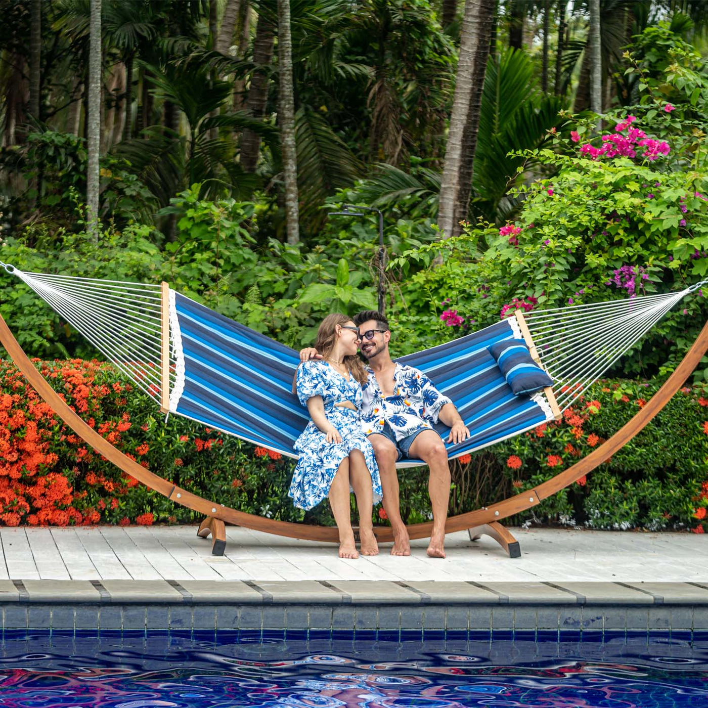 A man and woman lounging together on the Lazy Daze Sunbrella Double Quilted Hammock.#color_gateway-indigo