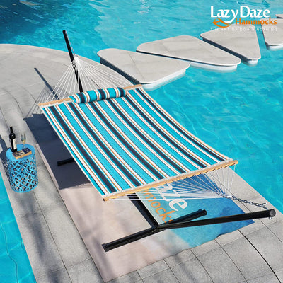 The Lazy Daze Sunbrella Double Quilted Hammock set up by the pool in a serene backyard.#color_gateway-mist