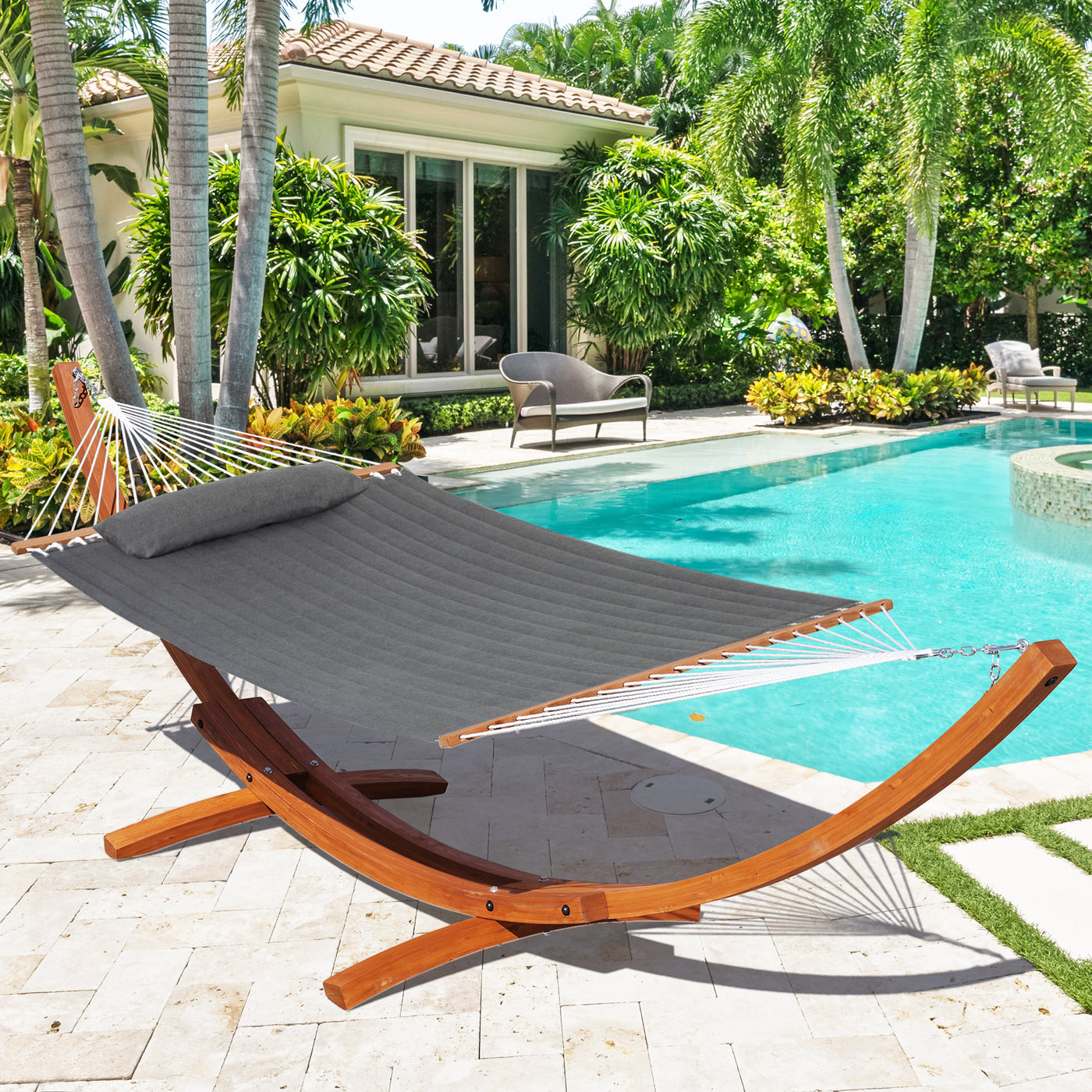 The Lazy Daze Sunbrella Double Quilted Hammock in Gray positioned next to the pool in a scenic backyard.#color_gray