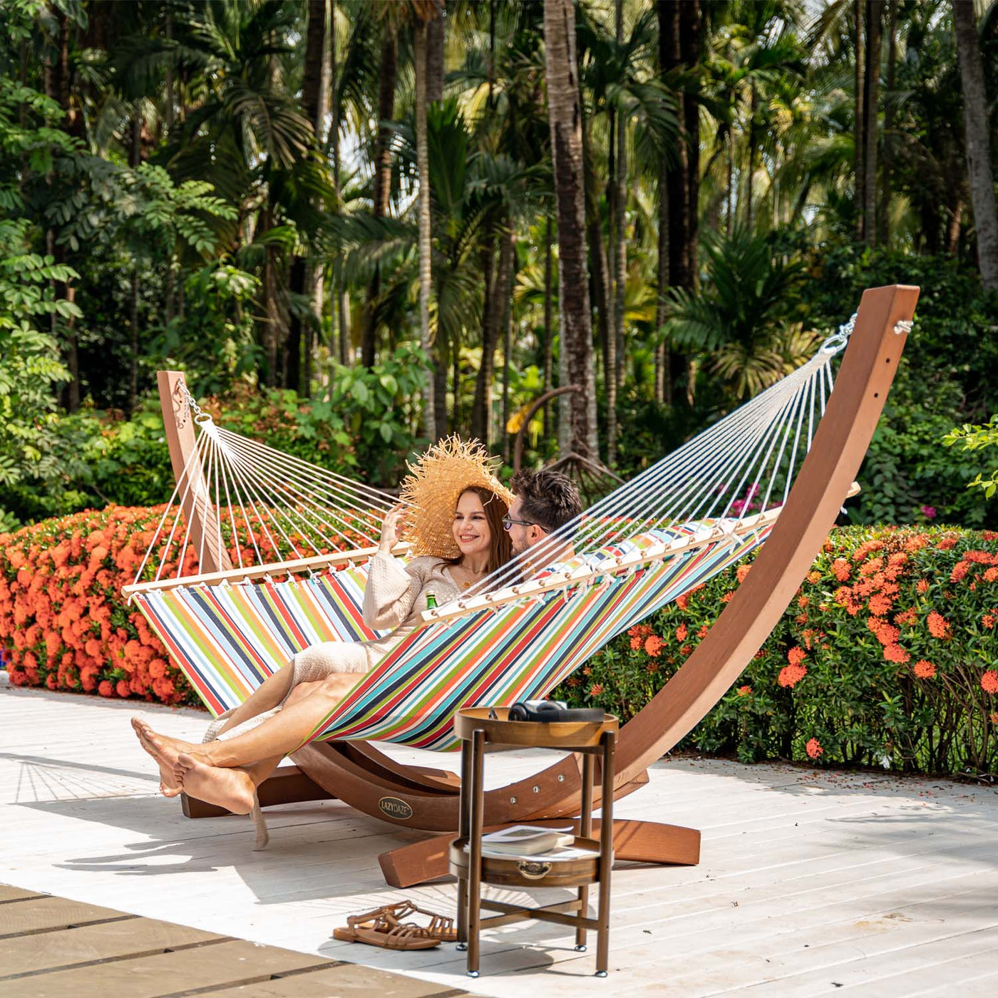 Enjoying comfort in Lazy Daze Sunbrella Single-layer Hammock in orange in the backyard.#color_orange