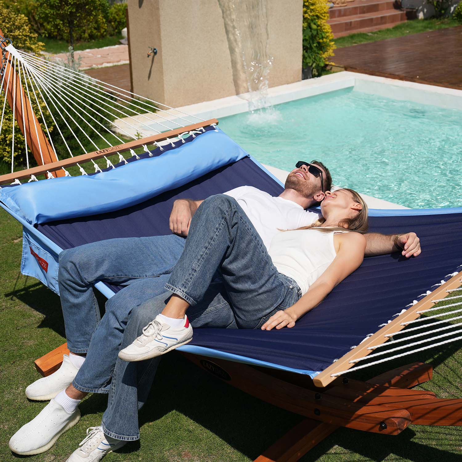 two person sitting on the Blue_Double_Quilted_Hammock__on_the_backyard.#color_blue