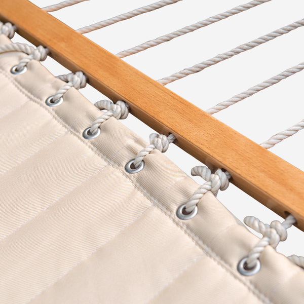detailed picture: Close-up of a hammock with wooden slats and white ropes.