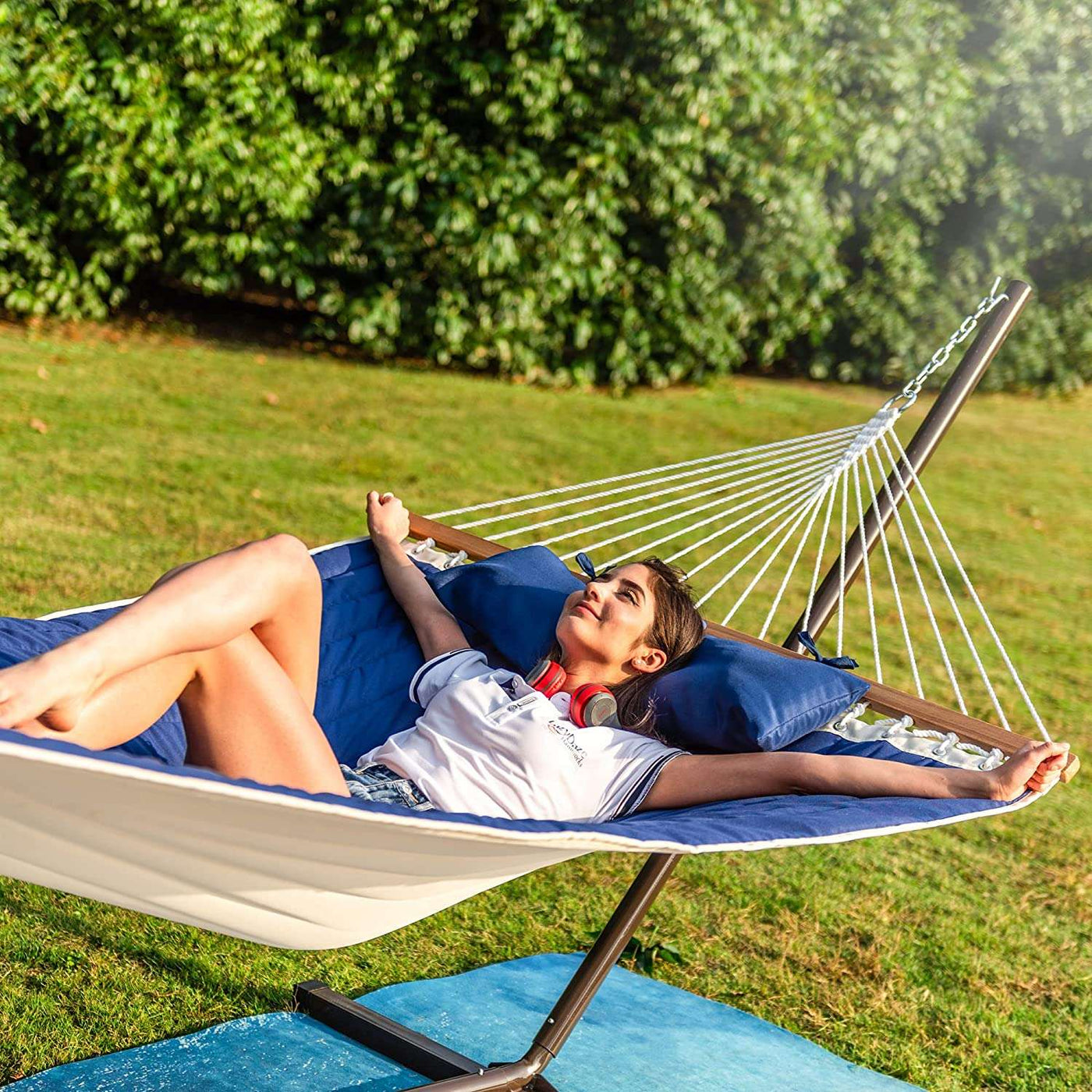 Lazy Daze Deluxe Quilted Fabric Hammock Combo in the backyard, perfect for relaxation.#color_blue