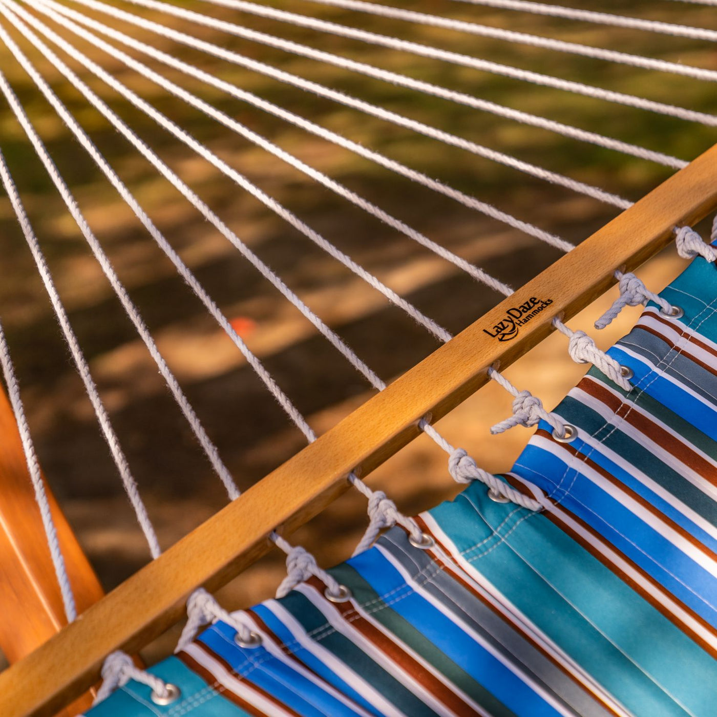 Handcrafted rope knot detail of the Lazy Daze Large Double Stripes Quilted Hammock.#color_peacock-stripes